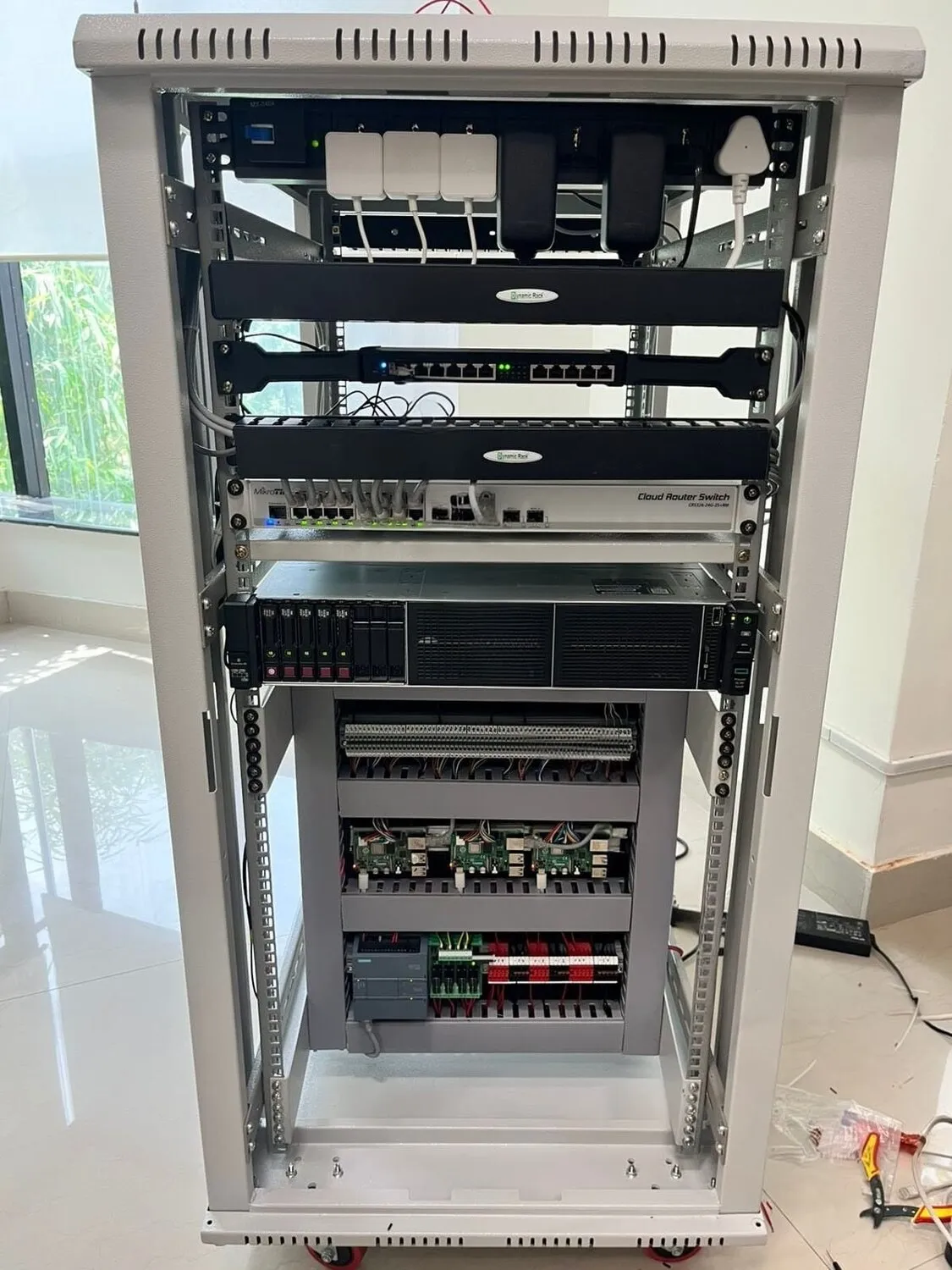 The testbed equipment rack: networking, controllers, and the station-level gear that ties the layers together.